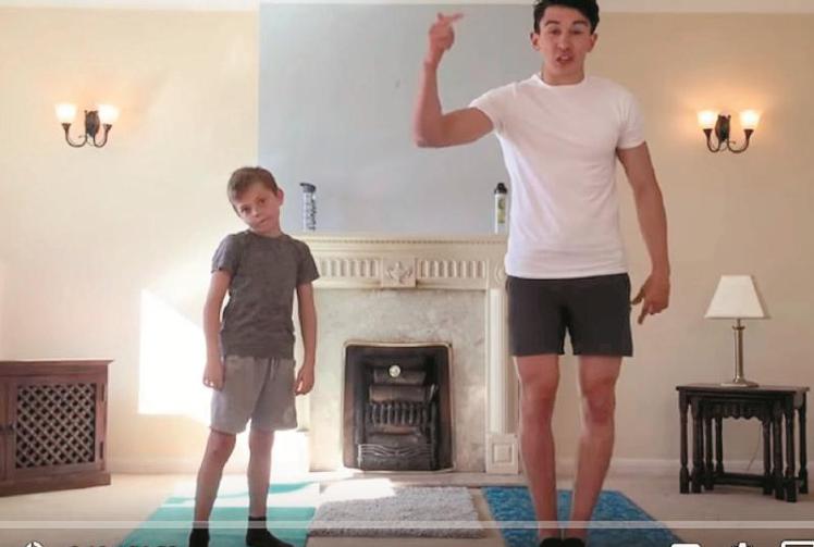 Ethan helps Sunderland's Luke O'Nien work out to raise cash for the NHS